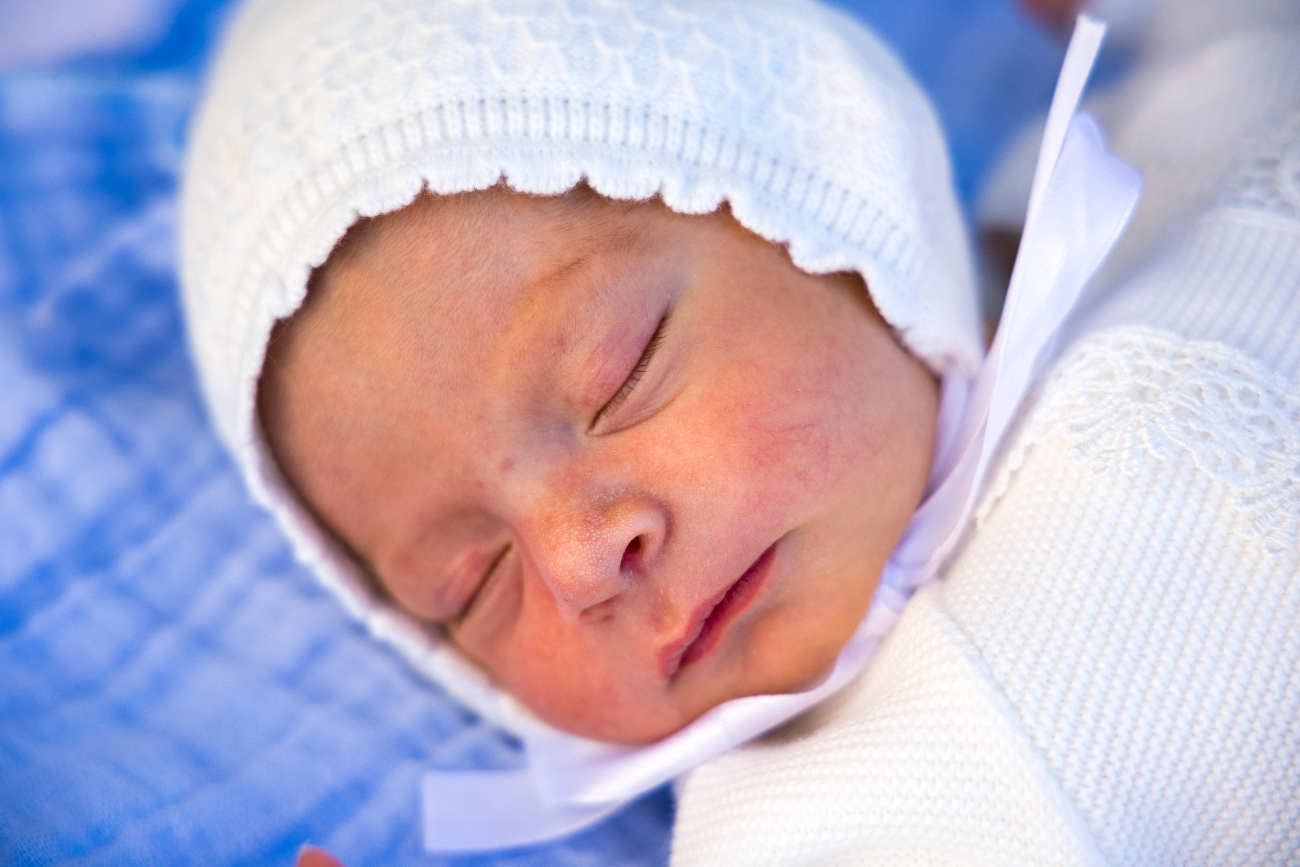 A sleeping newborn wrapped in white