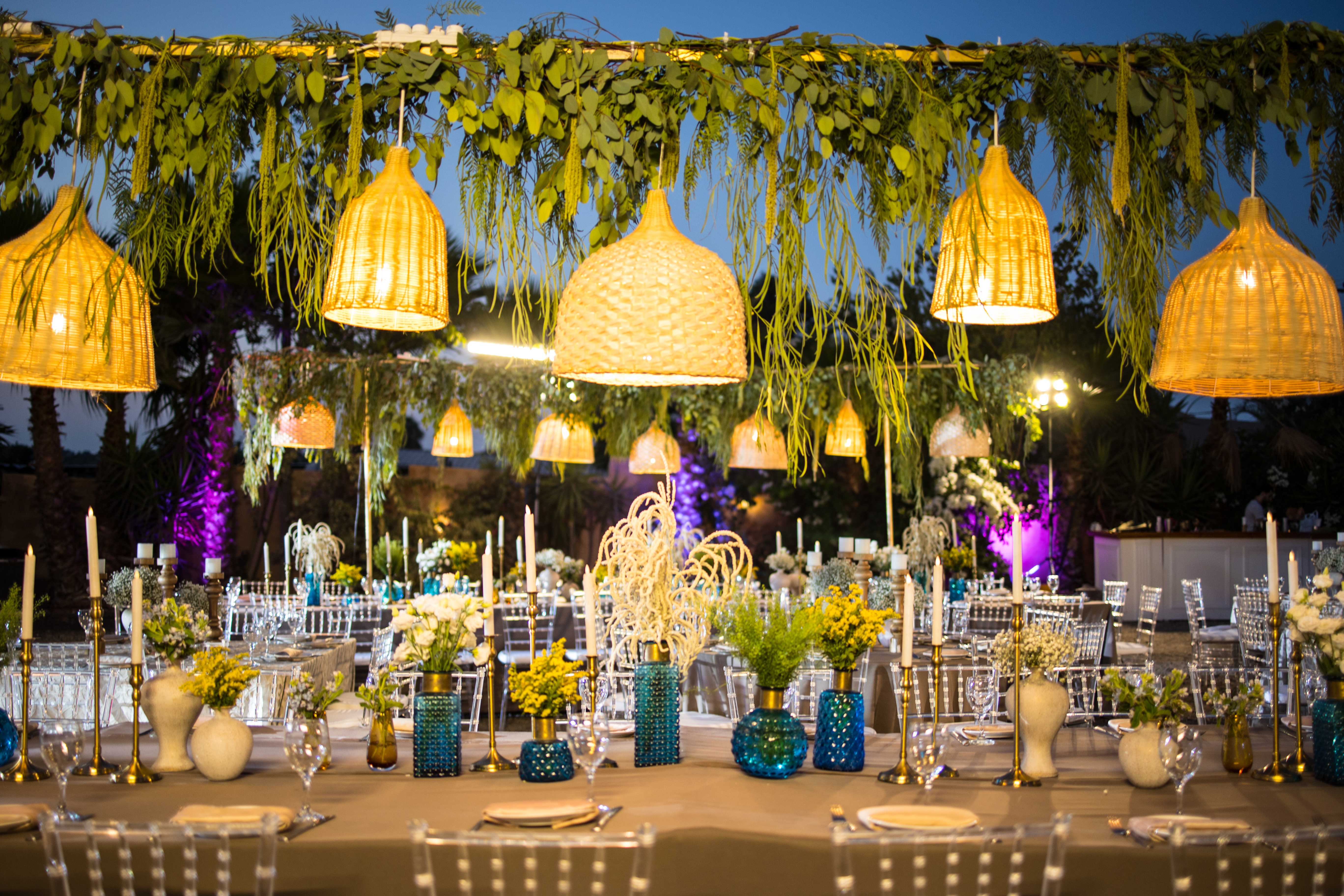 An outdoor event reception with woven pendant lights