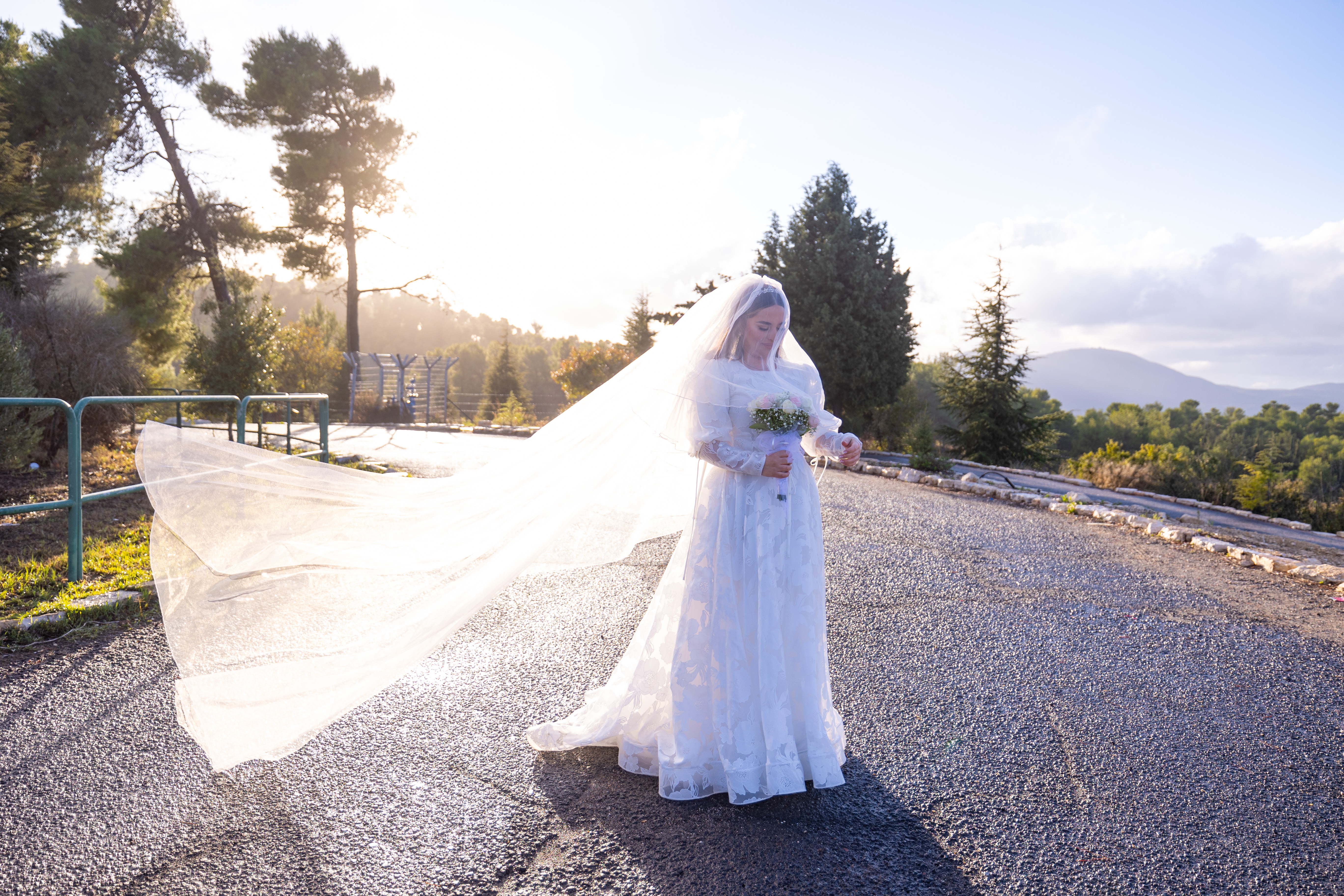 A bride with her veil in the afternoon light